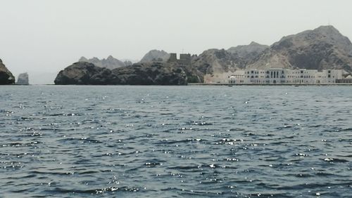 Scenic view of sea and mountains against sky