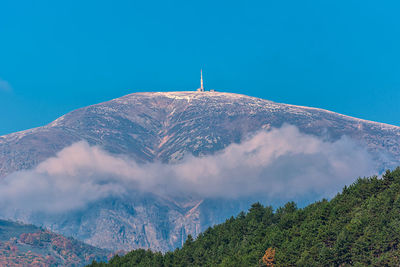 Scenic view of mountains against blue sky