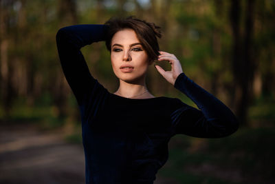 Portrait of young woman standing outdoors