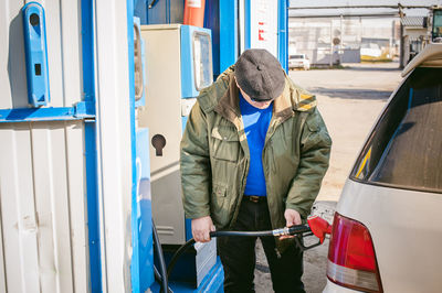 Man filling fuel in car