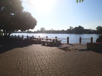 Footpath by sea against clear sky