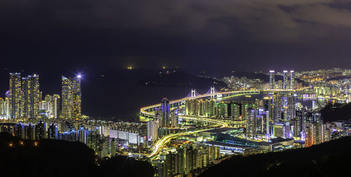 High angle view of illuminated buildings in city at night