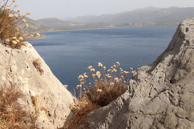 Scenic view of sea and mountains against sky