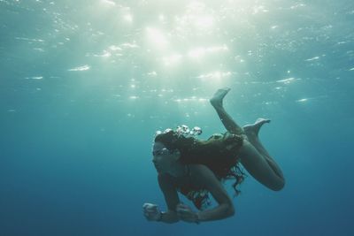 Young woman swimming in sea