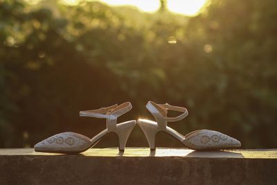 Close-up of shoes on wooden table