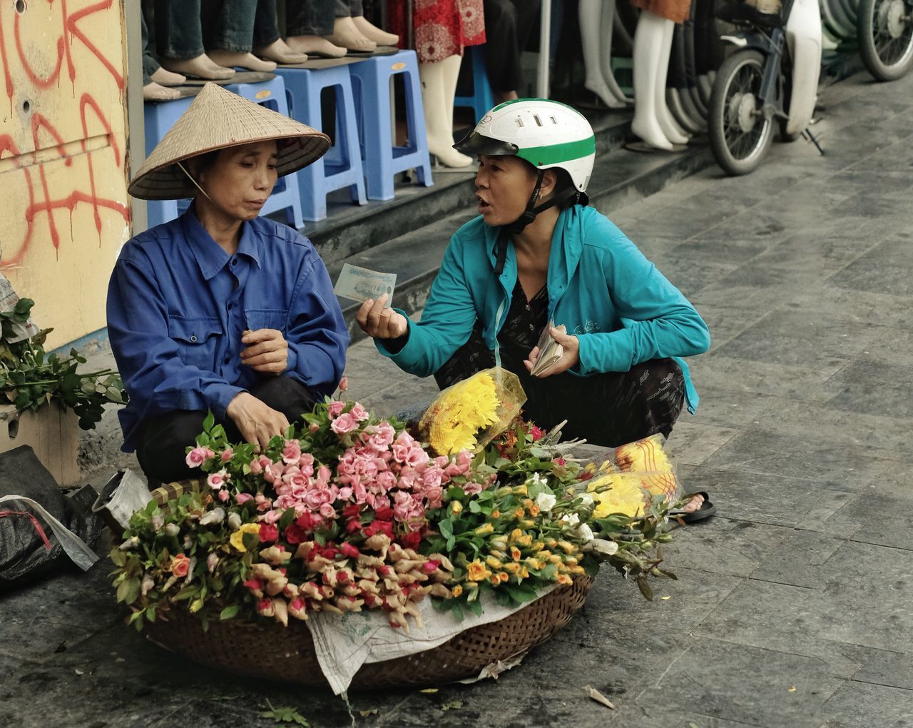 PEOPLE IN TRADITIONAL CLOTHING HOLDING FLOWER