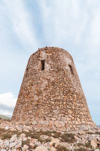 The tower of cala domestica. low angle view of historical building against sky