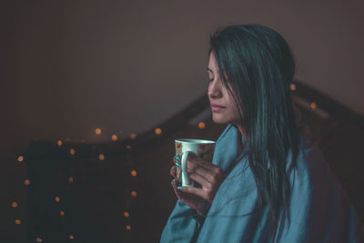 Close-up of woman using mobile phone at night