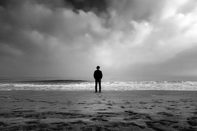 Rear view of man standing on beach