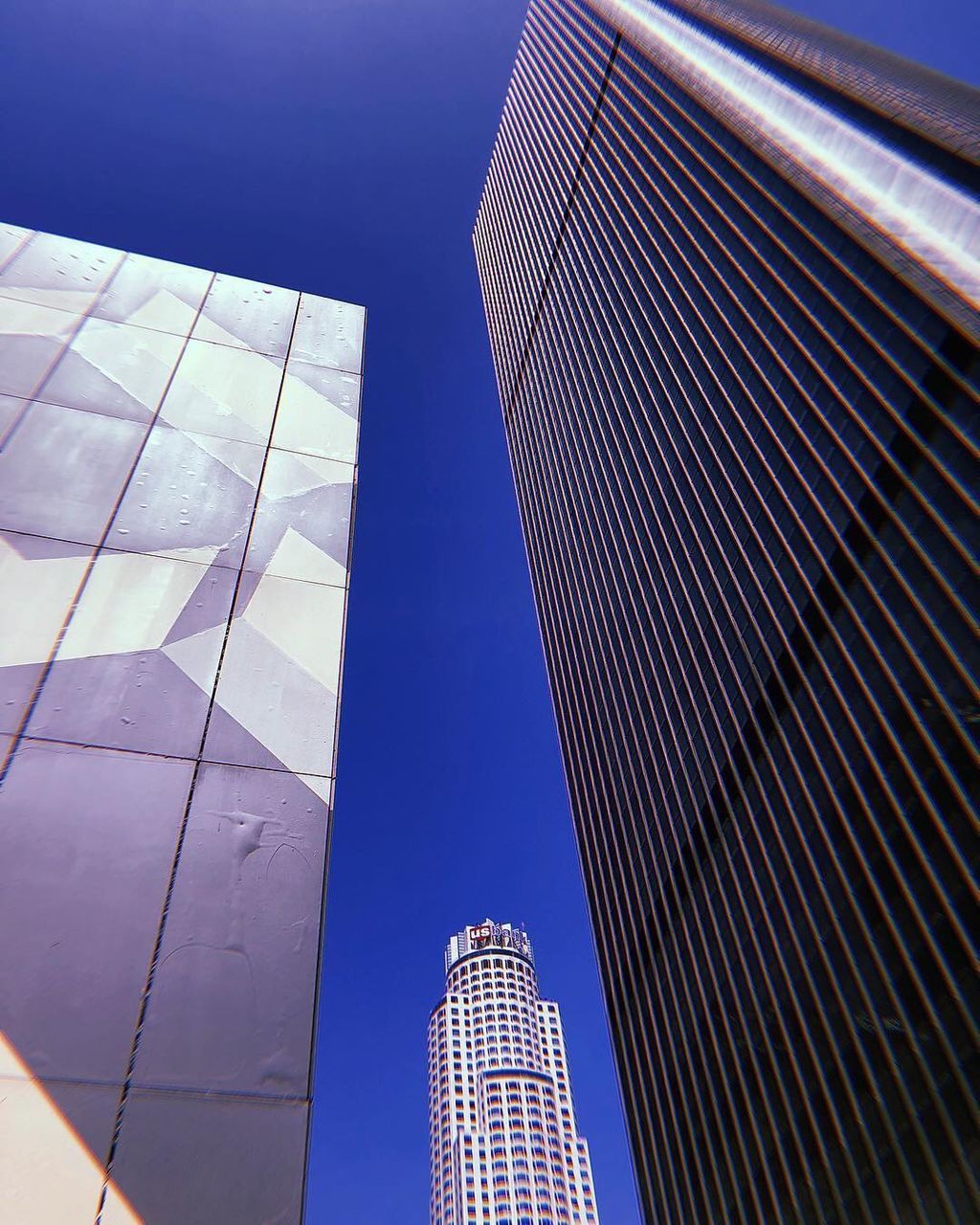 building exterior, built structure, architecture, building, office building exterior, tall - high, low angle view, skyscraper, office, city, tower, modern, sky, no people, nature, reflection, day, travel destinations, blue, outdoors, financial district