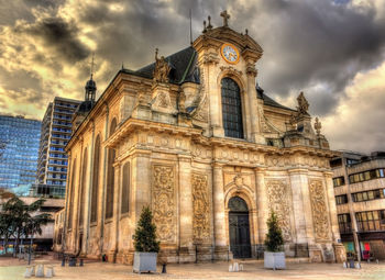 Low angle view of historical building against cloudy sky