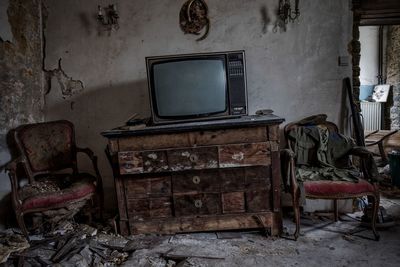 Chairs and table in abandoned room