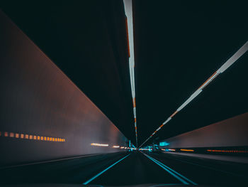 Low angle view of illuminated tunnel