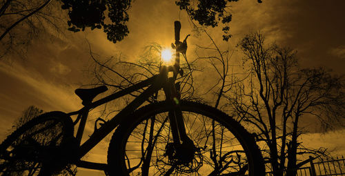 Low angle view of silhouette trees against sky during sunset