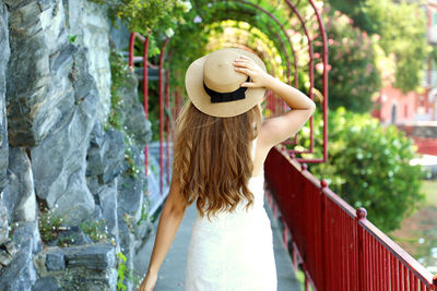 Rear view of woman wearing hat while standing outdoors