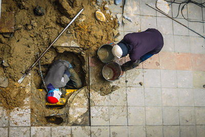 High angle view of man working on footpath