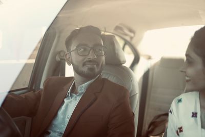 Portrait of young man sitting in car