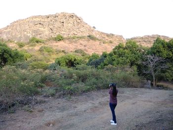 Rear view of man standing on mountain