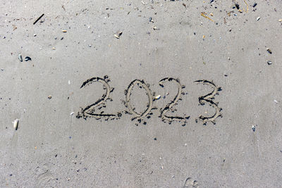 High angle view of text on sand at beach