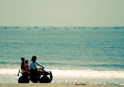 People on beach against sky