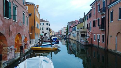 Boats in canal with buildings in background