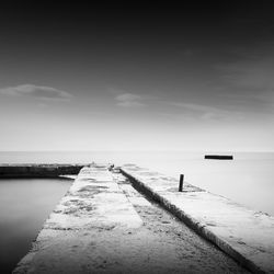 Pier amidst sea against sky during foggy weather