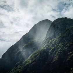 Scenic view of mountains against cloudy sky