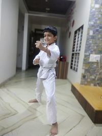 Portrait of boy standing in corridor