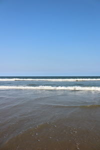 Scenic view of sea against clear blue sky