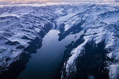 Aerial view of frozen sea by mountain