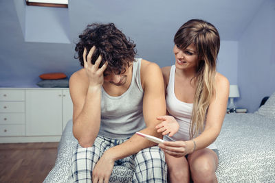 Young woman using mobile phone at home