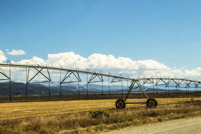 Scenic view of bridge over field against sky