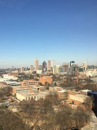 High angle view of cityscape against clear blue sky