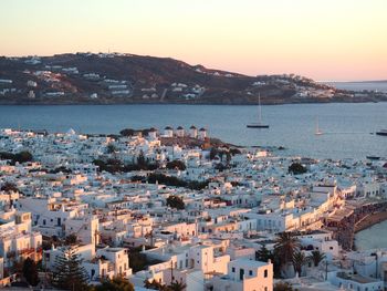 High angle view of townscape by sea against sky