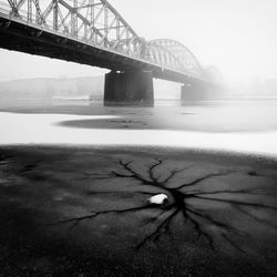 Bridge over road against sky during winter