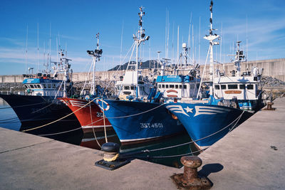 Fishing boats moored at harbor