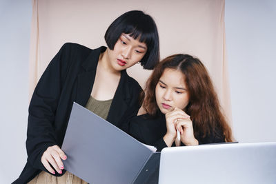 Lesbian couple working in office