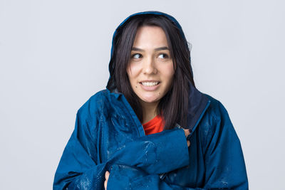 Portrait of young woman against white background