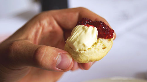 Cropped hand holding scone