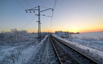 Railroad tracks against sky during winter