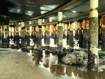 Reflection of illuminated lights on wet glass in building