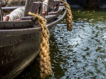 Rope tied to boat moored in river