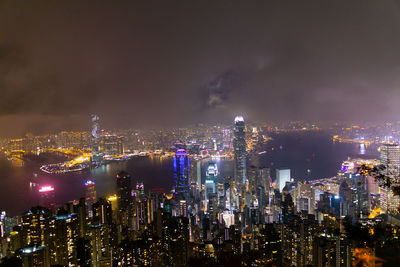 Illuminated cityscape against sky at night