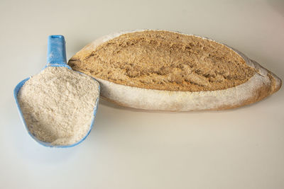 Close-up of bread on table against white background