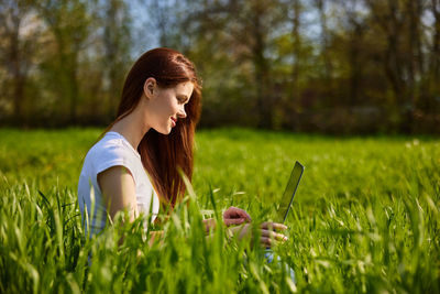 Young woman standing amidst plants