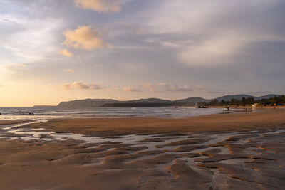 Scenic view of beach against sky during sunset