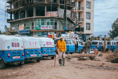People working at construction site in city