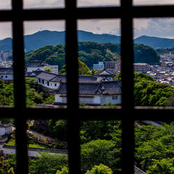 Buildings in city seen through window