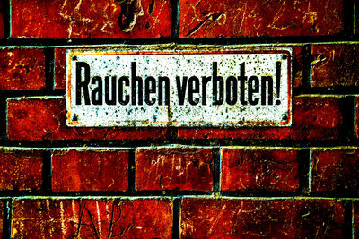 Close-up of text on brick wall