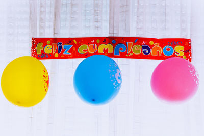 Close-up of multi colored balloons on paper